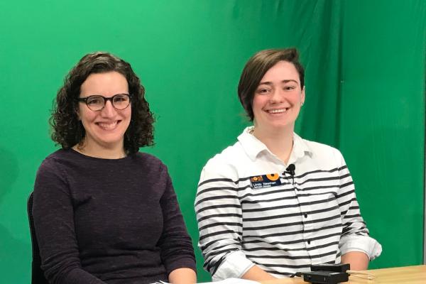 TPS Fellow Katie D'Amico and a COSI educator prepare to present in front of a green screen